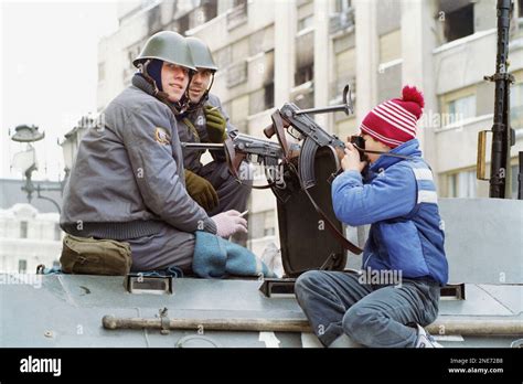 Two Romanian Soldiers Smile When A Youngster Take Their Picture In