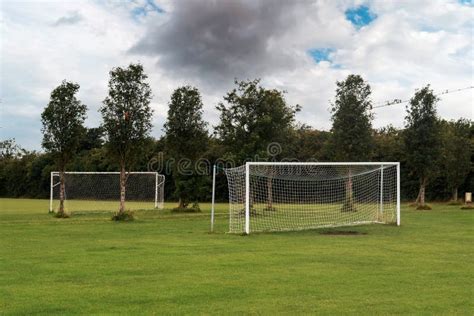 Two White Soccer of Football Goal Post on a Grass Field of a Training ...