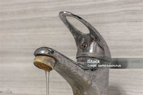 A Thin Stream Of Hard Water Flows From An Old Tap Aerator Old Bathroom