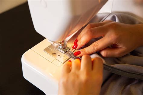 Woman Is Working At Sewing Machine Girls Hands With Red Manicure