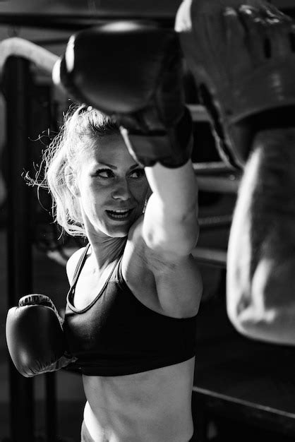 Premium Photo | Woman on boxing training with trainer