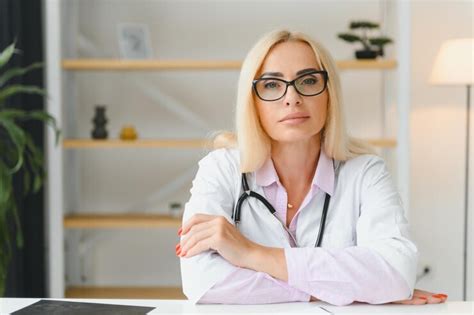 Premium Photo Portrait Of Middle Age Female Doctor Is Wearing A White Doctor S Coat With A