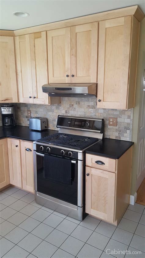 Small Shaker Kitchen With Natural Stained Cabinets And Black