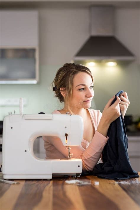 Beautiful Young Woman Sewing Clothes With Sewing Machine Stock Image