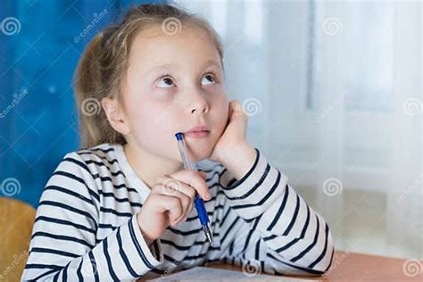 Dreamy Little Girl Sit At Desk Studying Look In Distance Visualizing Or