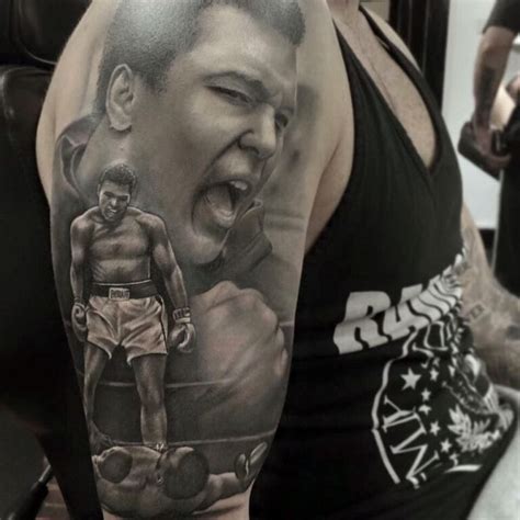 A Man With A Tattoo On His Arm Has A Boxing Scene In Front Of Him