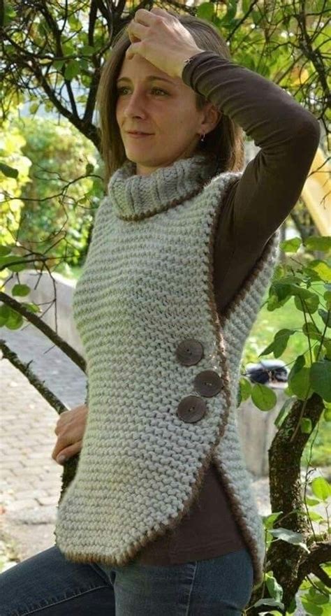 A Woman Wearing A White Knitted Sweater With Buttons On The Front And