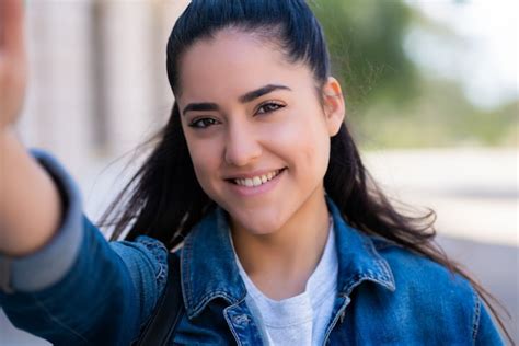 Premium Photo Portrait Of Young Woman Taking Selfies While Standing