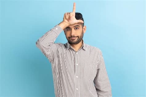 Premium Photo Businessman Holding Hand Near Forehead Showing Loser Gesture With Fingers Having