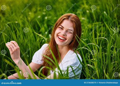 Portrait Of Laughing Woman Sitting In Tall Grass Stock Image Image Of