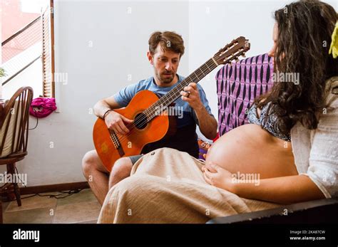 Romantic Young Man Plays Guitar To His Pregnant Wife A Young Brazilian