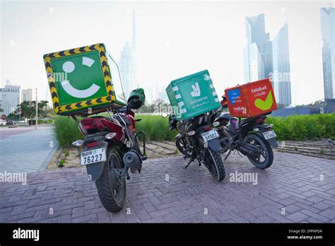 Motorcycle food delivery at parking lot. Dubai, United Arab Emirates - April 2023 Stock Photo ...