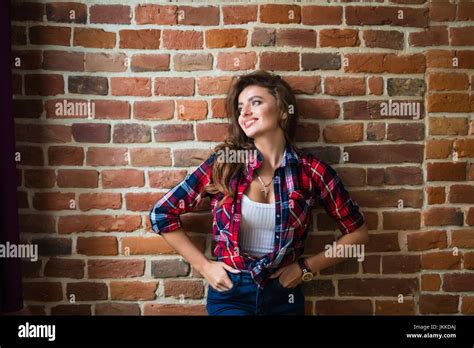Serious Brunette Woman Against Red Brick Wall Stock Photo Alamy