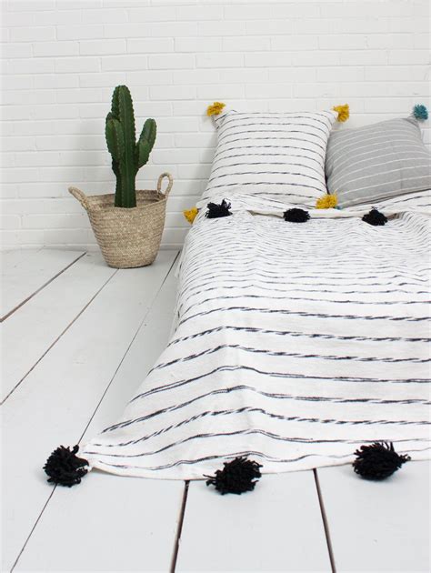 The Tassel Pom Pom Blanket In Grey A Handmade Stripe Blanket With