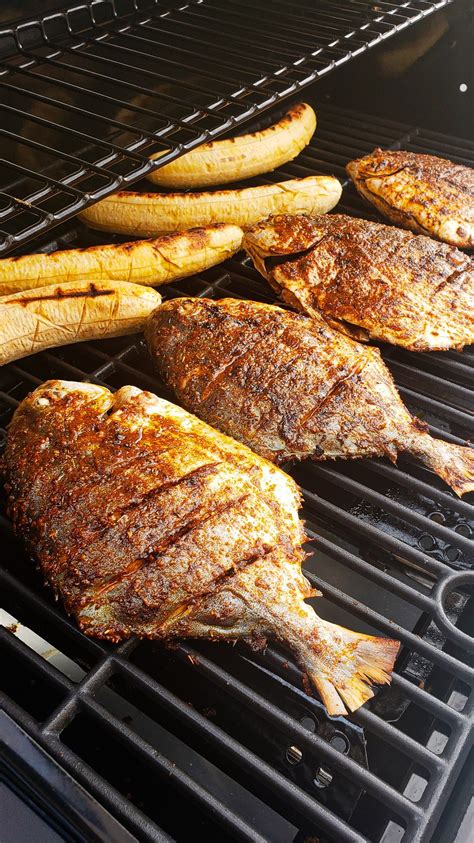 Juicy And Tasty Fish Bbq With Plantains And Veggies Grilled Fish