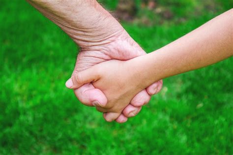 Premium Photo Grandmother Holds Her Granddaughters Hands People