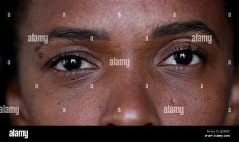 Black African woman opening eyes close-up face and eyes Stock Photo - Alamy