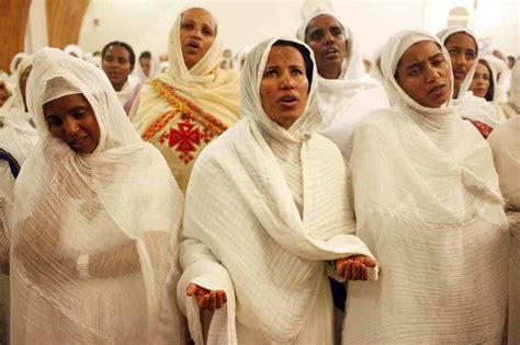 A Group Of Women In White Dresses Standing Next To Each Other