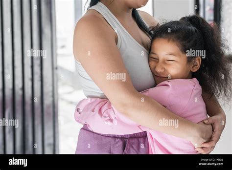 Beautiful And Tender Brown Skinned Girl Latina Hugging Her Mother With A Happy Face Daughter