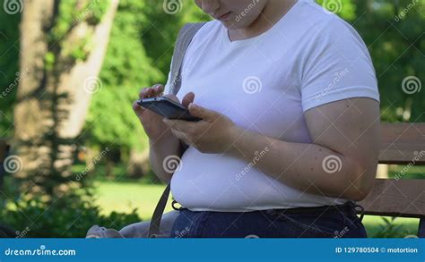 Plump Girl Sitting In Park Scrolling Pages On Smartphone Chatting With Friends Stock Footage