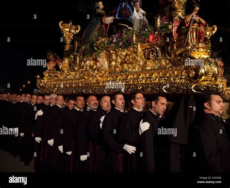 Costaleros Carrying A Religious Float Known As A Trono In The Semana