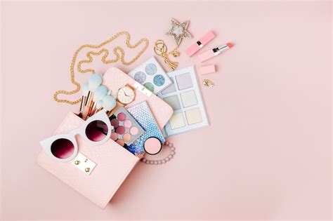 Premium Photo Cosmetic Products Flowing From Makeup Bag On Pastel Pink Background Flat Lay Top