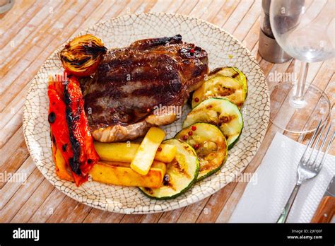 Delicious Grilled Beef Steak With Potatoes And Vegetables Stock Photo