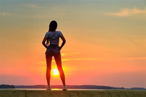 Premium Photo Rear View Of A Silhouette Of A Woman Standing On A Pier