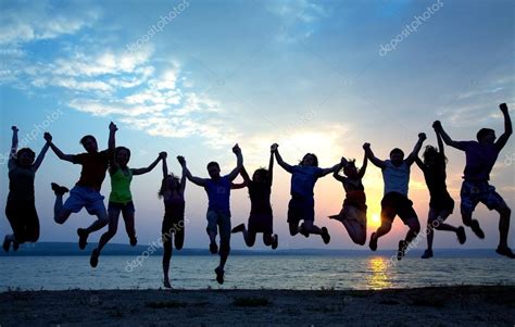 Group Of People Jumping On Beach Stock Photo By ©yanlev 76059085