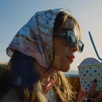 A Woman In Sunglasses And A Bandana Eats An Ice Cream Sundae