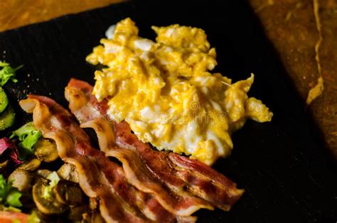 Scrambled Eggs With Bacon Mushrooms Served With Salad Tomato A Stock Image Image Of Bacon