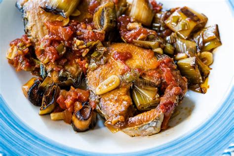 Bonito Fish Pieces With Tomato Sauce And Leek In Plate Baked In Oven