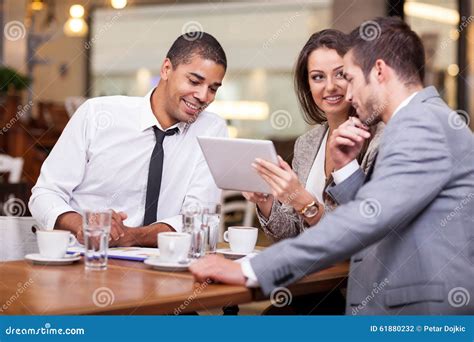 Young Businesspeople Having A Business Meeting At Coffee Shop Stock