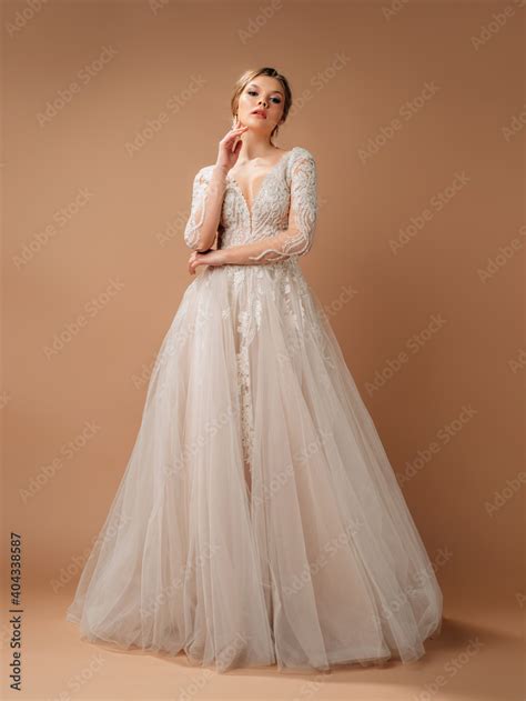 Elegant Lush Wedding Dress Blonde Model In White Lace Wedding Gown And Long Sleeves Posh And