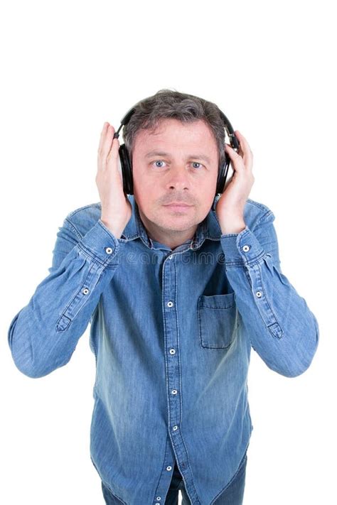 Portrait Of A Cool Handsome Man Listening To Music With Headphones On White Background Stock