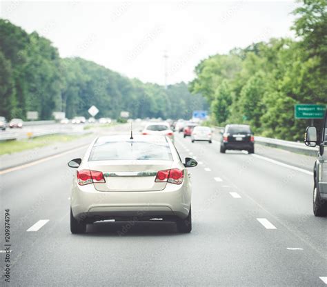 Commuter Economy Car Driving Down Road Rear View Stock Photo Adobe Stock