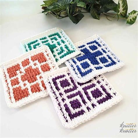 Four Crocheted Coasters Sitting On Top Of A Table Next To A Potted Plant