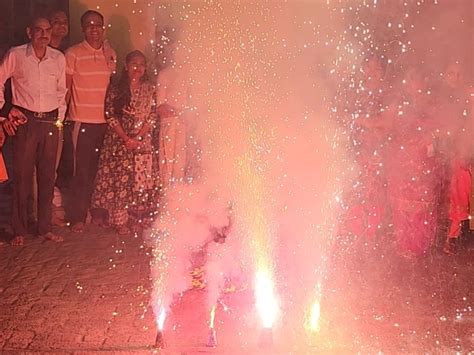 Worshiping Goddess Lakshmi Ganesh By Law Making Rangoli And Fireworks