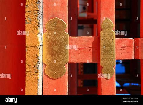 Antique Decorative Golden Stake On Red Wooden Gate Of Ancient Japan