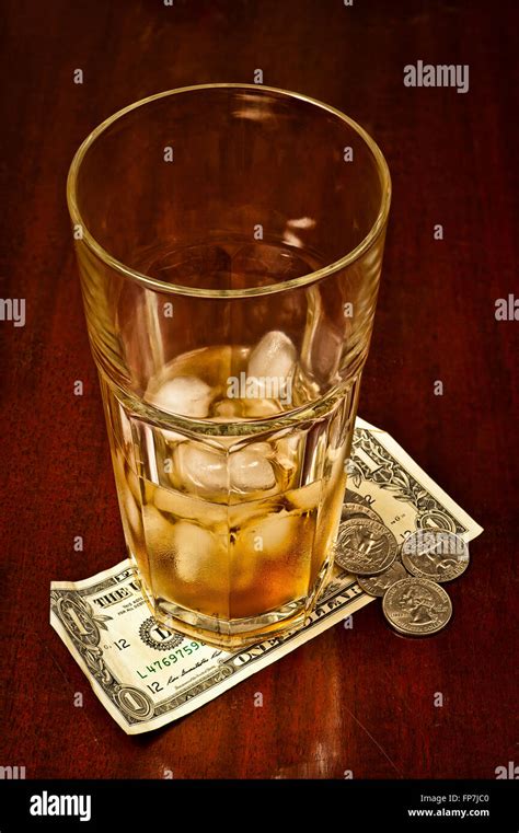 Drinking Glass With Tip Money Stock Photo Alamy