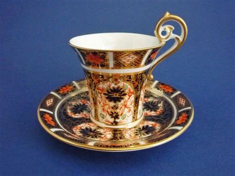 An Ornately Decorated Cup And Saucer On A Blue Background