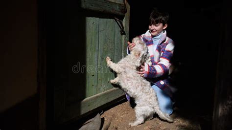 Poor Small Girl Playing With Dog Outdoors In Front Of House Poverty