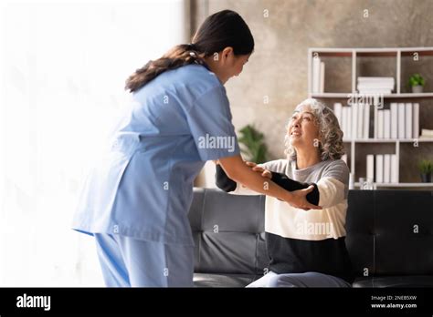 Young Caregiver Helping Senior Woman Walking Nurse Assisting Her Old