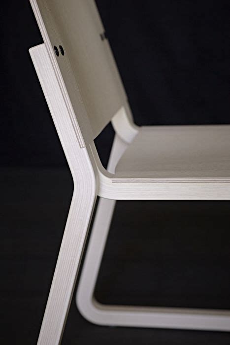 A White Chair Sitting On Top Of A Black Floor