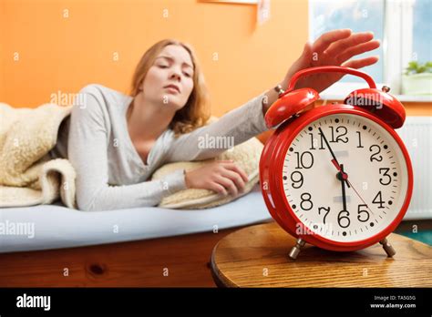 Exhausted Woman Waking Up In Bed Turning Off Alarm Clock Young Girl In