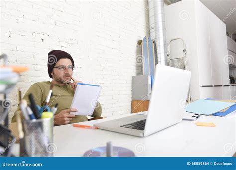 Young Attractive Hipster Businessman Working With Computer In Modern