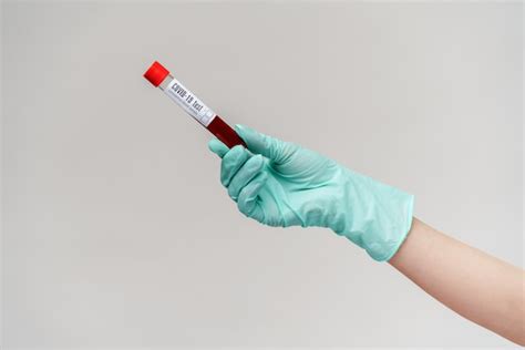 Premium Photo Hand In Latex Glove Holding Blood In Test Tube Close Up