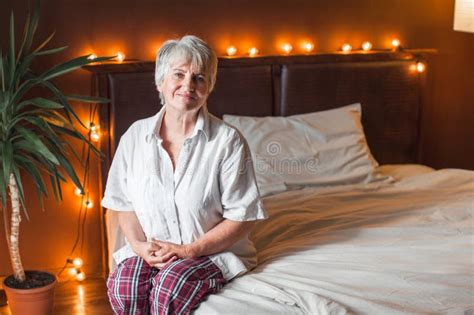 Senior Woman Stretching In Bed Waking Up At Home Stock Image Image Of Mature Pajamas