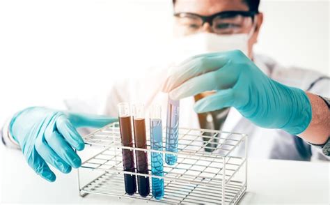 Premium Photo Close Up Of Scientist Putting Test Tubes In Rack On Table