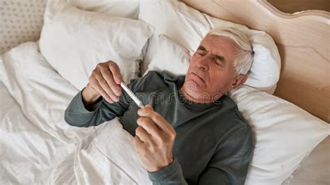 Mature Man Look At His Temperature On Thermometer Stock Image Image Of Blanket Health